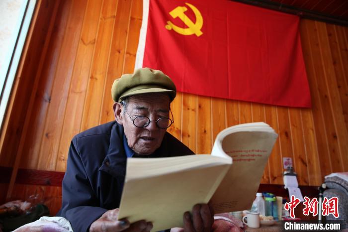 图为正在学习的藏族老人加保。　胡贵龙 摄